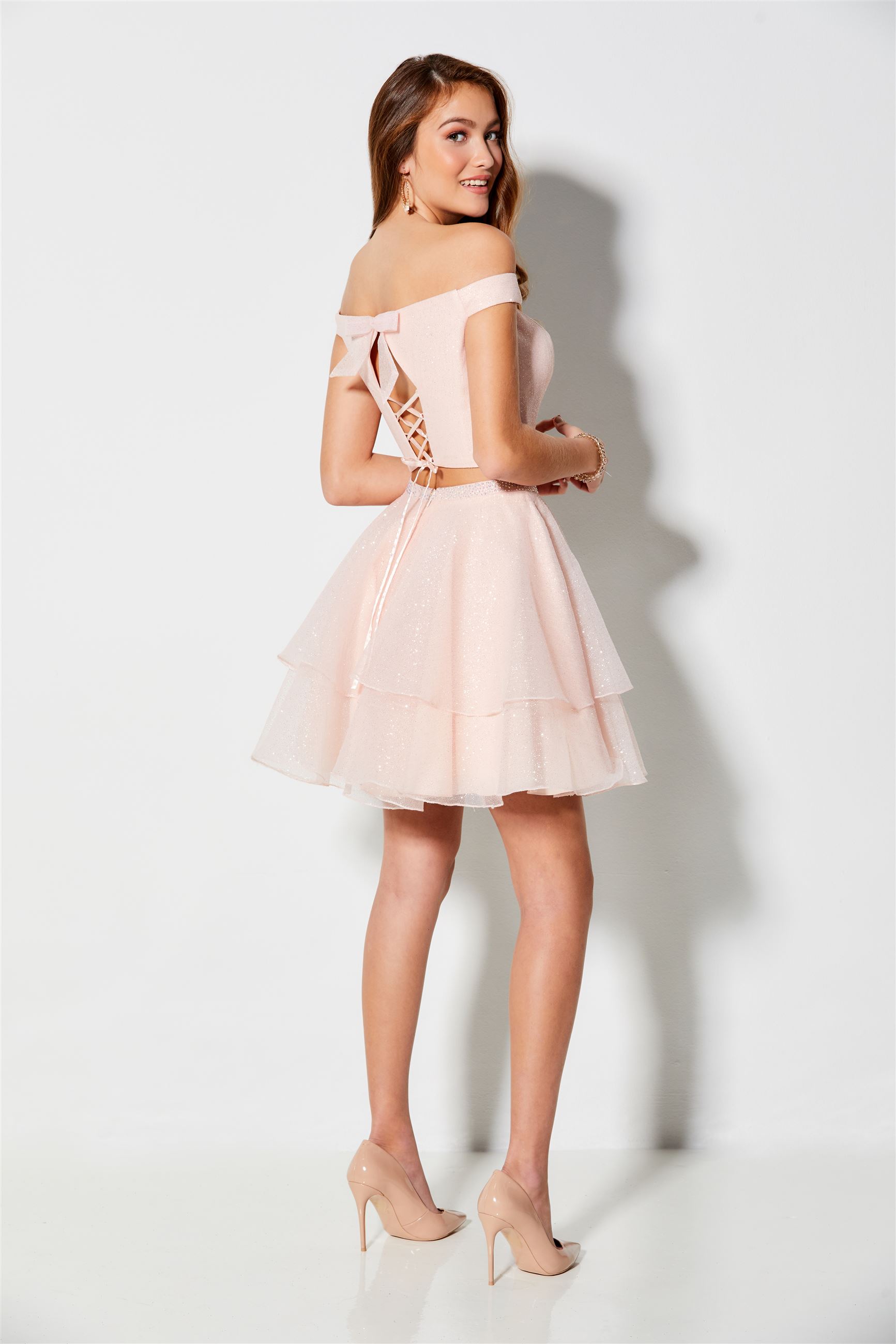 Brunette girl in pink two piece homecoming dress